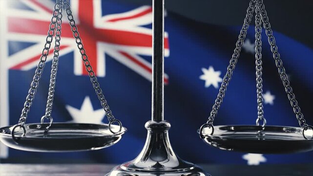 A set of balanced scales in front of the Australian flag, symbolizing justice and law