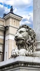 Stone lion statue perched atop an architectural element against a partly cloudy blue sky