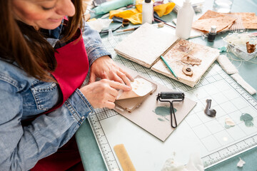 Woman Prints Paper for Scrapbook Project in Home Craft Area During Daylight Hours © GALDRIC