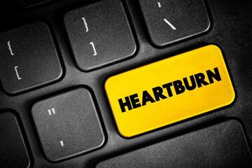 Fototapeta premium Heartburn is a burning feeling in the chest caused by stomach acid travelling up towards the throat, text button on keyboard, concept background