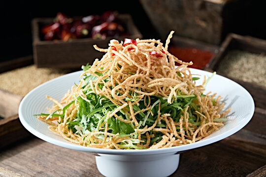 Fried dough twists with bitter chrysanthemum salad