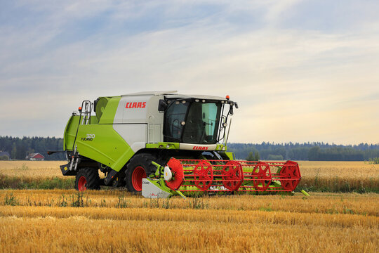 Claas Tucano 430 Combine Harvester in Field at Dusk.