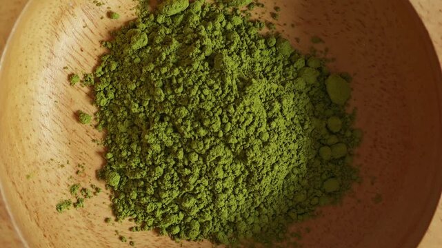 Matcha powder in wooden bowl.