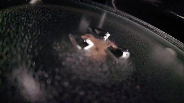 HD close-up of a clean microwave interior with a glass turntable and "For Microwave Oven Only" text. Perfect for UI testing, digital food overlays, or equipment demos.