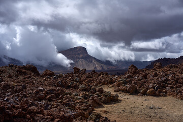 Mount Guajara through storm clouds above lava field © Xalanx