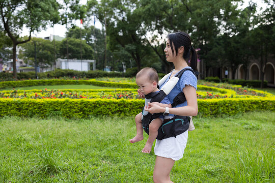 Mother carry baby with carrier at park