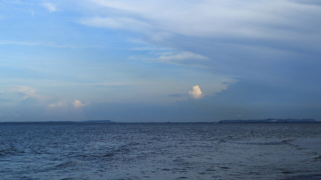Thick white clouds were in the sky above the sea