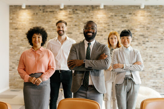 Confident business team smiling in office group portrait