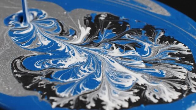 Close-up of liquid paints mixing into a beautiful abstract pattern