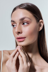 Stunning young woman with a gentle gaze and soft features captured in a serene setting