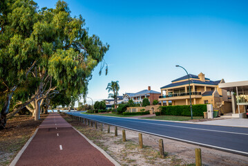 Red shared path curving past modern homes along Canning River in Shelley suburb, Perth, Australia, 16 March 2021