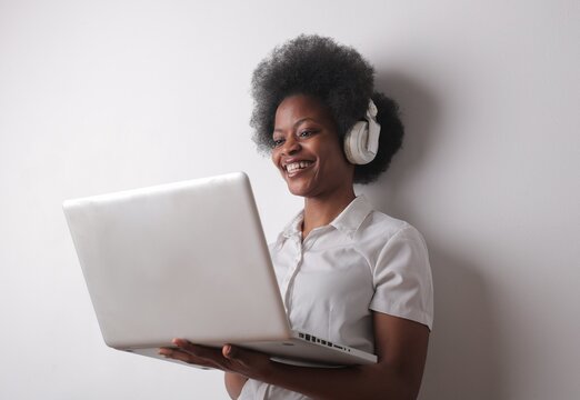 smiling woman uses a laptop