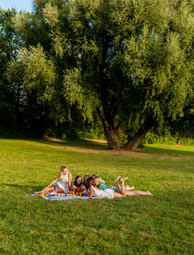 Group of women doing a picnic in the park on a beautiful day of summer