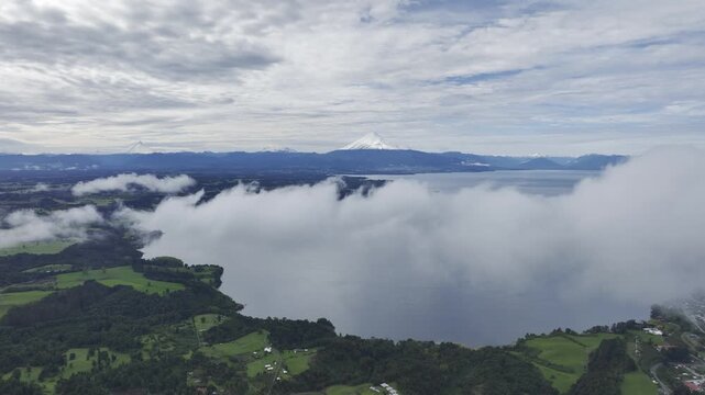 Drone shot of Andes with volcanoes and Puerto Octay city on Lake Llanquihue in Los Lagos, Chile