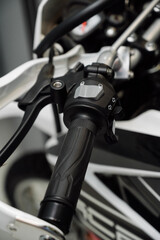 Motorcycle steering wheel with ergonomic grip and switch.