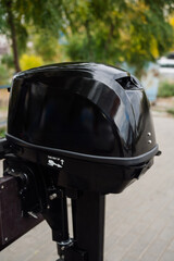Fototapeta premium Outboard motor in the showroom: close-up of the hull and tiller.