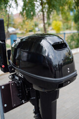 Fototapeta premium Outboard motor in the showroom: close-up of the hull and tiller.