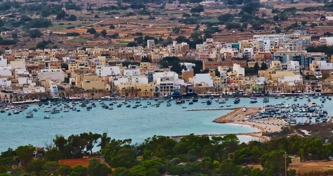 Aerial view of the Port of Marsaxlokk In Malta. A small fishing village with traditional colorful boats