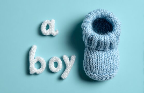 A pair of newborn boy shoe on blue background.