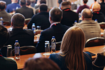 Fototapeta premium Conference, hall with audience, panel discussion at forum, people on a congress together listen to speaker on stage at convention, plenary session at business lecture seminar, venue for presentation