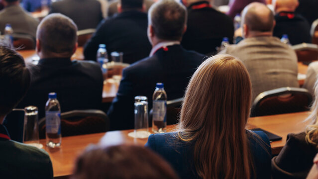 Conference, hall with audience, panel discussion at forum, people on a congress together listen to speaker on stage at convention, plenary session at business lecture seminar, venue for presentation