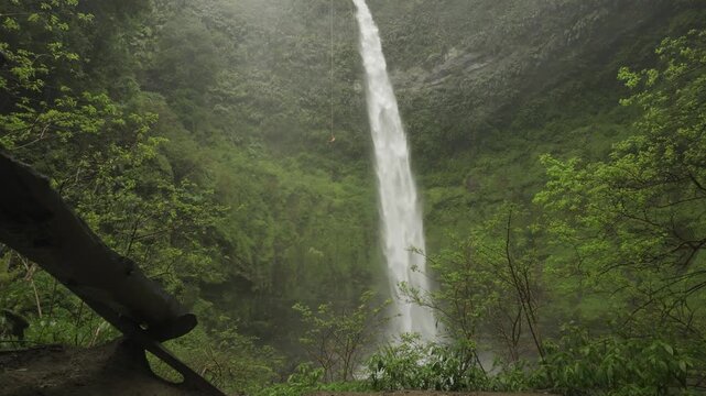 Person practices rappelling down El Salto del Claro waterfall in scenic Araucania landscape