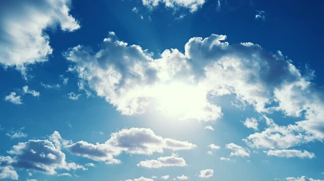 Luminous timelapse video showing clouds drifting across a vivid blue sky while sunlight shines brightly. The accelerated motion highlights atmospheric movement, natural light, and the calm rhythm 