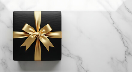 A beautifully wrapped black gift box with a luxurious gold ribbon sits on a marble surface. Evoking feelings of anticipation and celebration.