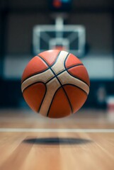 Naklejka premium Basketball soaring through indoor basketball court