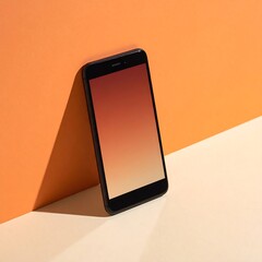 Black smartphone leans against orange wall, display glows with a gradient from red to cream
