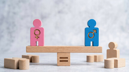 Pink female and blue male wooden figures standing perfectly on balance scale representing gender equality and fairness concept with harmony showing equal rights