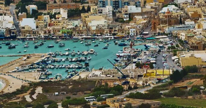 Aerial view of the Port of Marsaxlokk In Malta. A small fishing village with traditional colorful boats