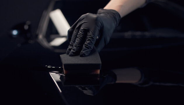 Hand applying ceramic coating to car paint