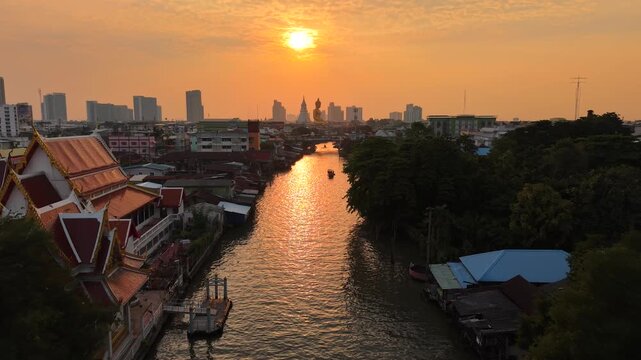 Aerial view Wat Paknam Bhasicharoen with wooden boat on river located in Phasi Charoen district, Bangkok, at the Chao Phraya River. It is part of the Maha Nikaya fraternity and is the origin of the Dh