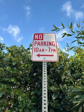 Restricted Parking Sign: A street sign indicating "No Parking 10am - 7pm" mounted on a pole for traffic control.