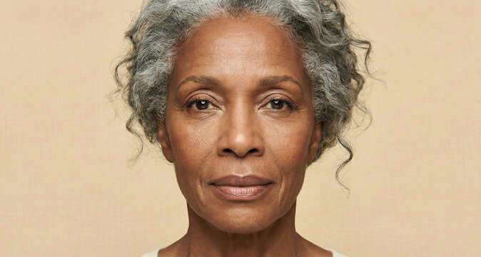 Close up portrait of a african american senior woman, showing deep wrinkles. Aging skin care for the face and eyes. Focusing on skin health. Beauty, anti-aging cosmetics.