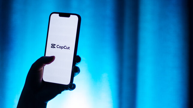 Kaliningrad, Russia - 12.11.2025. Smartphone screen in woman hands displaying logotype of popular application for video editing CapCut. Video edit app