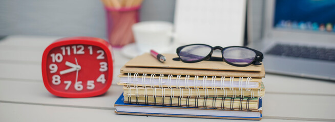 Desk for student education concept. Calendar, Laptop, Pencils, book, note pad placed on School table for student work online at home-banner image. © prachid