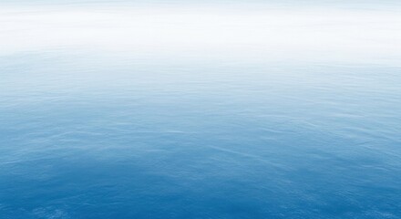 Obraz premium A serene blue ocean with gentle waves and a clear sky.