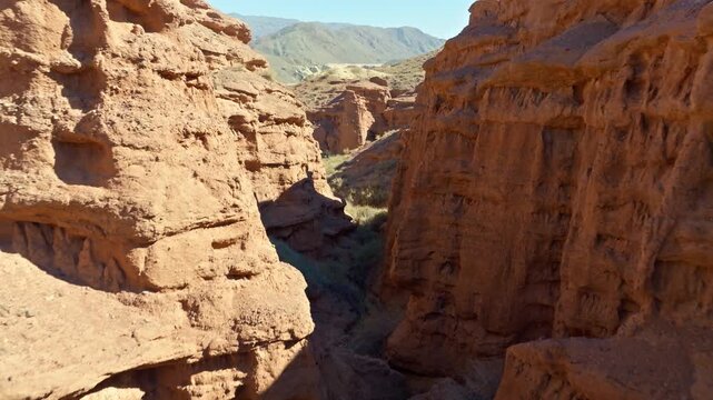 Aerial view of narrow zigzagging eroded sandstone Konorchek canyon in Kyrgyzstan desert