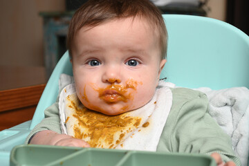young child facing forward with applesauce on his face
