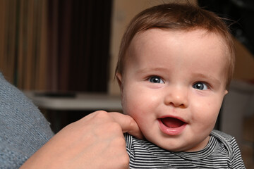 close-up of a mother playing with her smiling young child