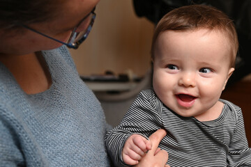 close-up of a mother playing with her smiling young child
