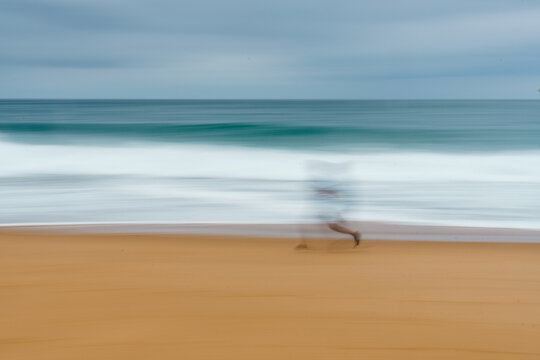 Blurred figure running on the beach in Labenne, Landes, France