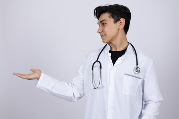Fototapeta premium Doctor in white coat presenting something with open hand