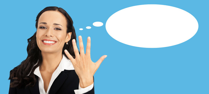 Businesswoman in black suit blazer shows five fingers, isolated blue background. Happy smile gesturing brunette woman at studio. Business success concept