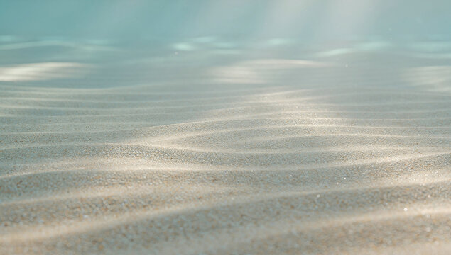 Underwater view of sandy sea bottom with sunlight rays