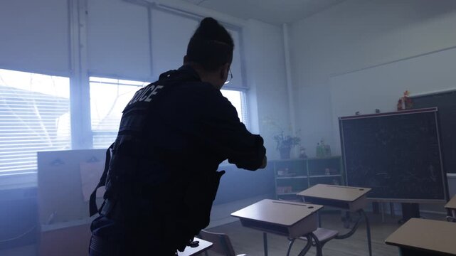 Police officer in a classroom at night arrest action scene