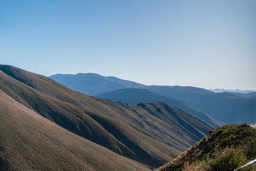 The mountains are covered in trees and the sky is clear