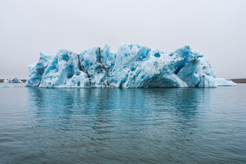 Huge piece of ice or melting iceberg in the cold water. Vatnajökull National Park, Jökulsárlón or "glacial river lagoon", largest - active glacial lake with blue icebergs or ice melting. Iceland. © LifeCollectionPhoto
